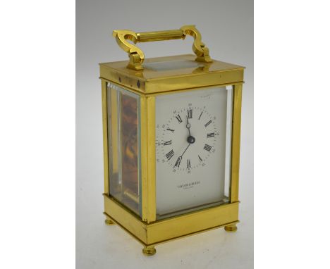 A lacquered brass carriage clock the 8-day drum movement with white dial signed Taylor & Bligh, 15 cm high overall Condition 