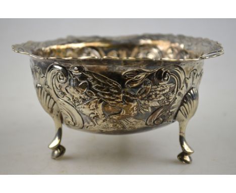 An 18th century Irish sugar basin with engraved and shaped rim and embossed and chased sides decorated with a squirrel and a 