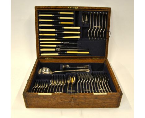 An oak canteen from Goldsmiths & Silversmiths Co. Ltd., containing a set of A1 plated flatware for six including soup ladle, 