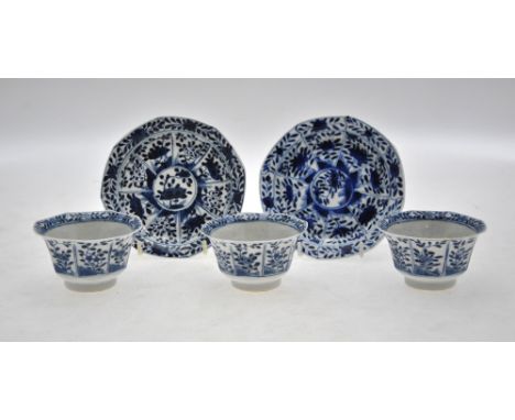 Three 18th century Chinese blue and white tea bowls and two matching saucers decorated with panels of flowers and foliage, be