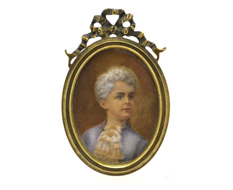 An oval portrait miniature of a boy in 18th century costume, in brass strut-frame
