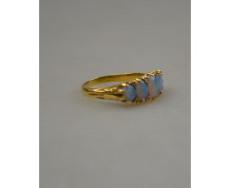 A black opal five stone ring with rose points between, 18ct yellow gold carved claw setting, size Q