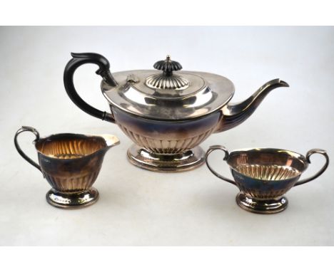 A heavy quality silver three-piece tea service of oval half-reeded form, E H Parkin & Co. Ltd. (probably), Sheffield 1974, 30