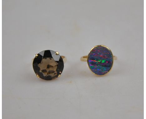 An opal doublet single stone ring stamped 9ct to/w smoky quartz ring, 9ct yellow gold claw set (2)