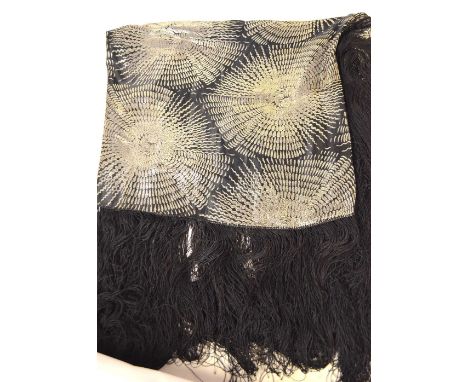 A 1920's Chinese black silk satin shawl with silvered stylized chrysanthemums, 130 x 96 cm plus 48 cm fringing Condition Repo