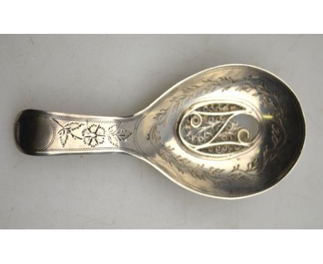 A George III silver caddy spoon, the sifter bowl with filigree grill within engraved floral and seaweed decoration, Samuel Pe