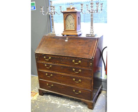 An 18th century mahogany bureau with fitted interior over four long graduated drawers, raised on shaped bracket feet