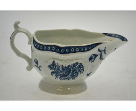 An 18th century Worcester porcelain sauce boat, circa 1770-72, of fluted shape with embossed panels painted in blue with form