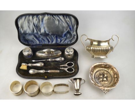 A cased silver manicure set, including toothbrush, Chester 1913 (replacement nail-scissors), to/w a silver sugar basin, four 