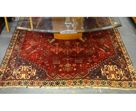 A Persian Hamadan carpet, the scattered geometric symbols on a red ground, 290 x 200 cm