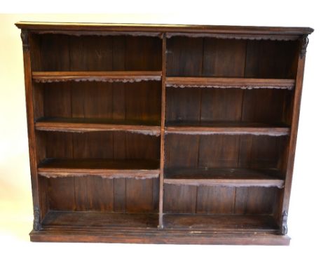 A Victorian oak library open bookcase, divided into two rows of three adjustable shelves, retaining tooled leather edges, rai