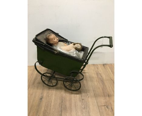 A VINTAGE KIDS PRAM WITH DOLLS
