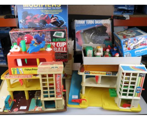 Group of mixed vintage toys to include 2 x Fisher Price garages, boxed Tomy Super Cup Football, boxed Tomy Turnin Turbo Dash 