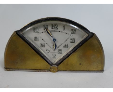 An Art Deco Travel Clock with Closing Self Winding Brass Cover, of Demi Lune Shape, 15cm Wide