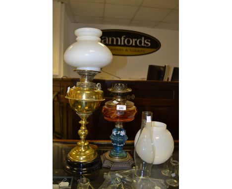 A Victorian oil lamp, amber glass reservoir; another brass oil lamp (2)