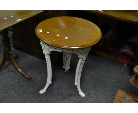 A wrought iron Coalbrookdale style, white painted, garden table, later top 