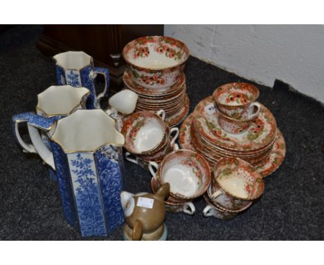 Ceramics - a Staffordshire part tea service; a set of three graduated blue and white jugs, picked out in gilt, reg shape no14