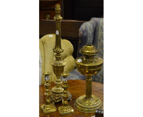Metalware - a brass oil lamp; a decorative table lamp; a pair of brass ejector candlesticks
