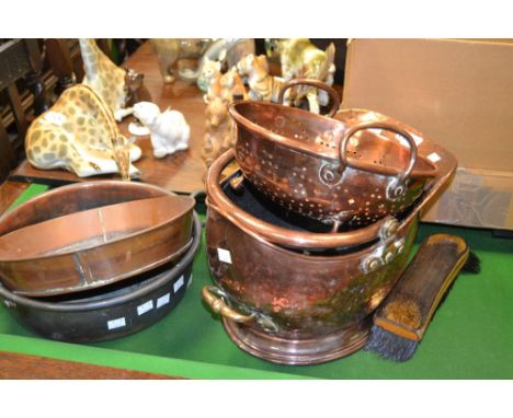 A beaten copper helmet shaped coal bucket; a copper colander; a twin handled bowl;  etc (4)