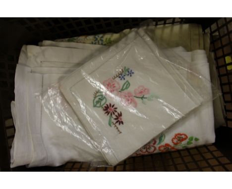 A box of various embroidered textiles 