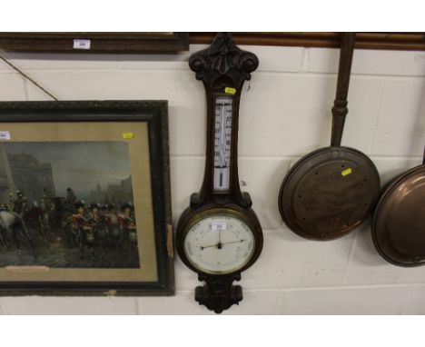 An Edwardian carved oak barometer 