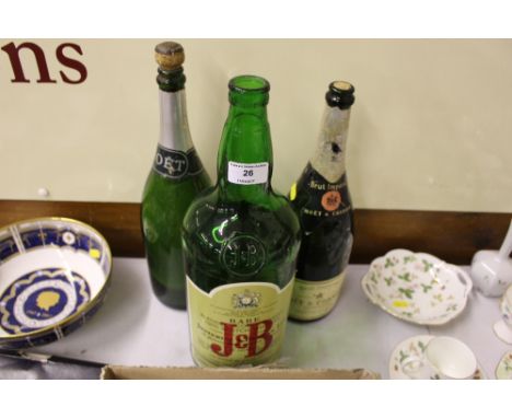 Two green glass Champagne bottles and a green glass Scotch whisky bottle