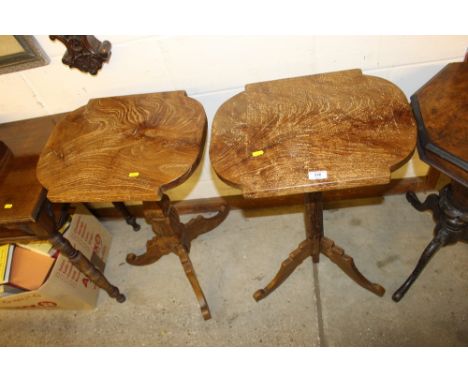 A near pair of elm occasional tripod tables 
