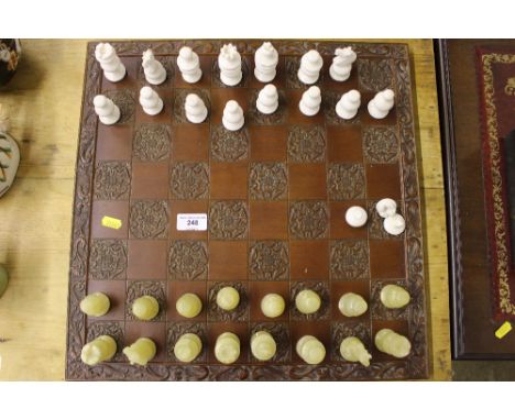 An onyx chess set  AF; together with a hardwood chess board