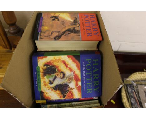 A box of Harry Potter novels and C S Lewis novels 