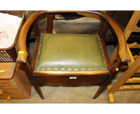 A 1930's leather upholstered piano stool with lift up top
