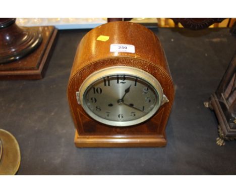 An Edwardian mahogany two hole mantel clock