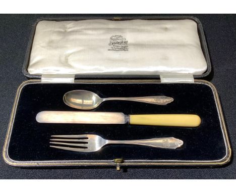 A George V christening set, comprising bone-handled knife and a silver spoon and fork, Cooper Brothers and Sons, Sheffield 19