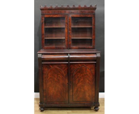 A Victorian mahogany library chiffonier, coronated cornice above a pair of glazed doors enclosing two adjustable shelves, the