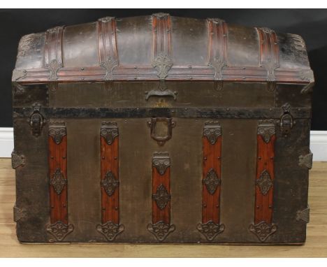 A hardwood mounted metal dome top trunk, hinged cover, applied throughout with geometric strapwork, 71cm high, 92.5cm wide, 5