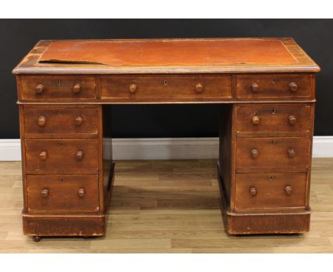 A late Victorian oak twin pedestal desk, rectangular top above three frieze drawers, three further drawers to each pedestal, 