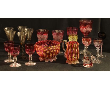 A cranberry glass uranium flecked milk jug and sugar bowl, a cranberry flashed hock glass; cranberry wine and liqueur glasses