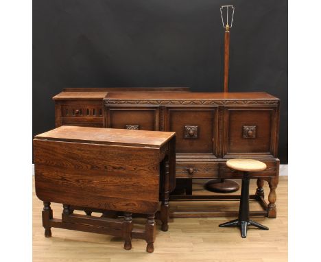 An oak sideboard, rectangular top with shallow half-gallery above a pair of nulled frieze drawers and a pair of linenfold pan