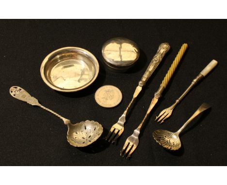 A Victorian silver pierced sugar sifting spoon, London c.1890, marks indistinct; another smaller; a George V silver domed cir