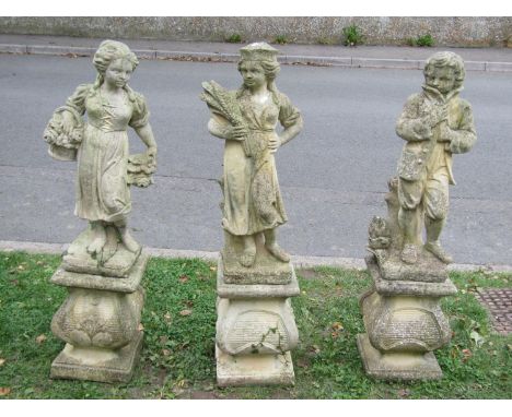 Three weathered cast composition stone garden ornaments representing three of the four seasons raised on loose squat pedestal