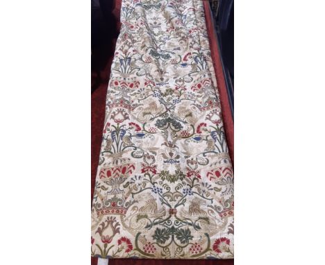 A pair of good quality extra long curtains in a heavy woven brocade type fabric of heraldic and classical motifs. Lined and w