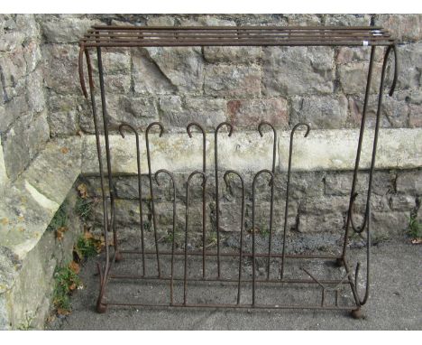 A weathered iron work boot stand/rack with simple open scroll detail beneath a strap work top/shelf, 91 cm high x 88 cm x 33 