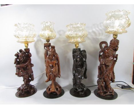 Four Chinese root carved table lamp figures, two fishermen, one Laughing Buddha and one farmer, each with a decorative glass 