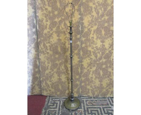A vintage plated standard lamp with octagonal pillar raised on a twelve sided swept platform base, 125cm high (excluding fitt