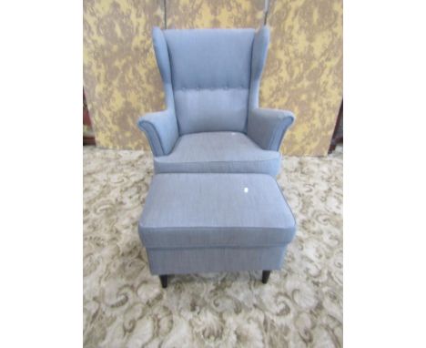 A contemporary wing-back button-back elbow chair with associated foot stool (2) 