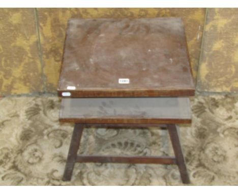 A vintage oak potters table/stand with revolving square top raised on square cut and splayed supports united by stretchers, 4
