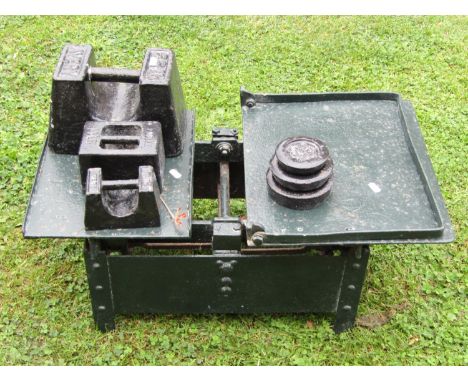 A heavy duty set of antique iron agricultural scales, with painted finish and associated weights.
