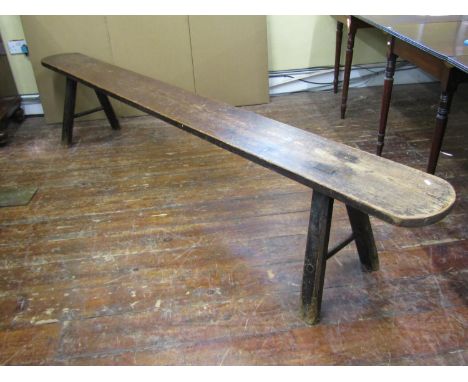 An antique pine bench on splayed supports, 51cm high x 268cm long x 27cm deep