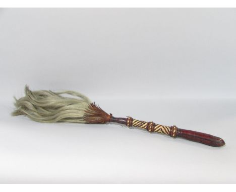 A vintage African horse hair fly swot with a leather and cane bound handle. 