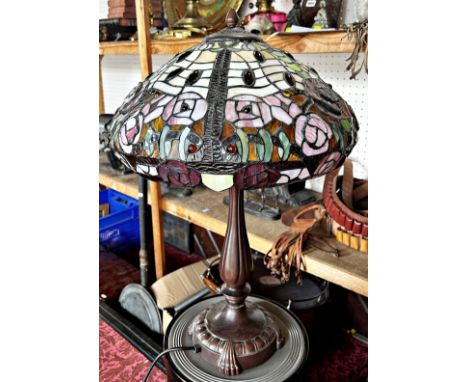 A Tiffany style table lamp with a floral leaded shade 60cm high. 