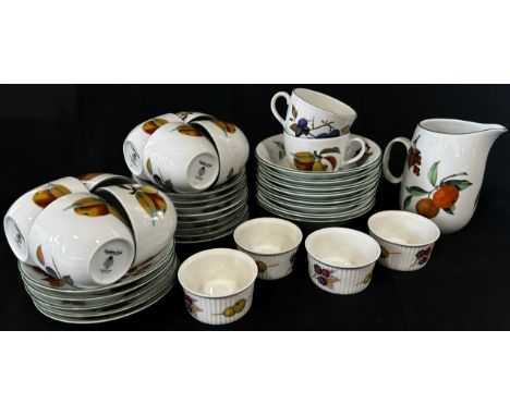 A collection of Royal Worcester Evesham Vale pattern table ware, comprising cups and saucers, graduated plates and bowls